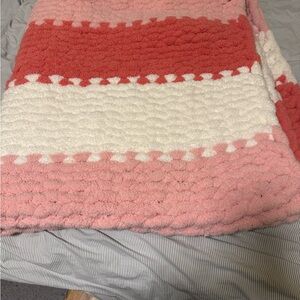 Pink and white hand knit blanket